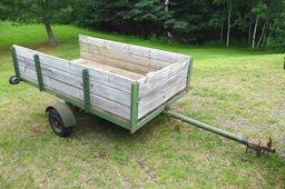 Two wheel metal framed trailer with wood sides and bottom. Approx. 7' x 4' x 17" high. Tire size is