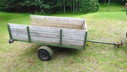 Two wheel metal framed trailer with wood sides and bottom. Approx. 7' x 4' x 17" high. Tire size is