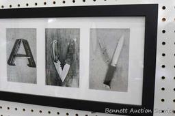 Framed "Navy" print with each letter a collage of weaponry is 21-1/2" x 9-1/2" and was donated by