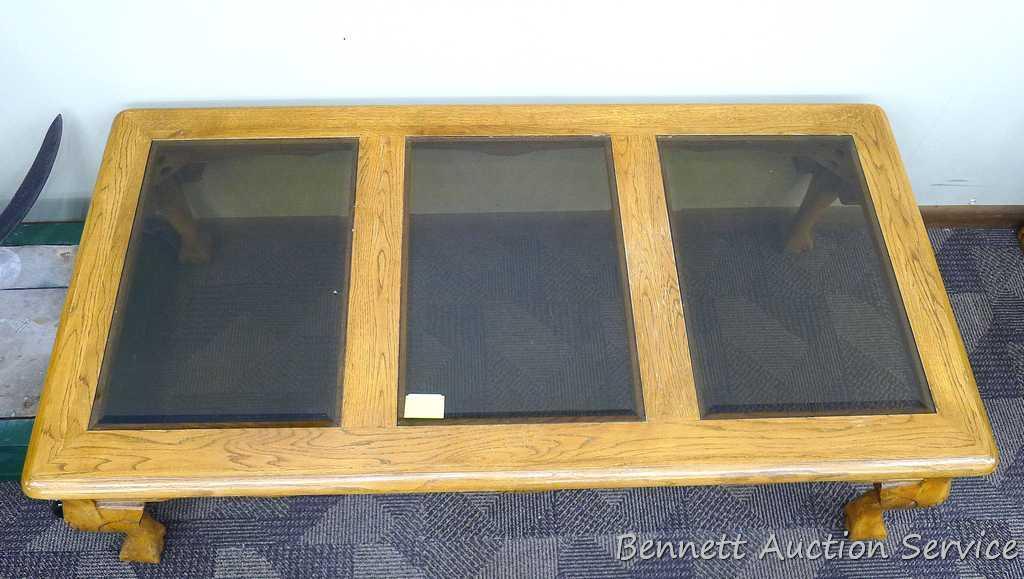 Wooden coffee table with 3 smoked colored glass panels for the table top; very sturdy; has a few