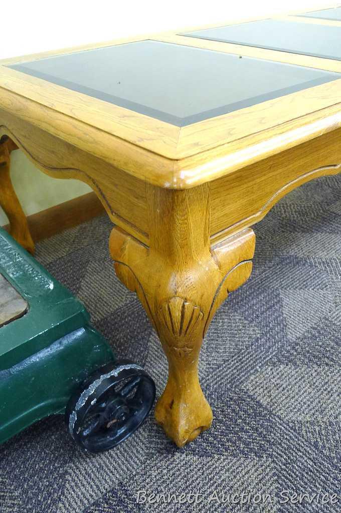 Wooden coffee table with 3 smoked colored glass panels for the table top; very sturdy; has a few