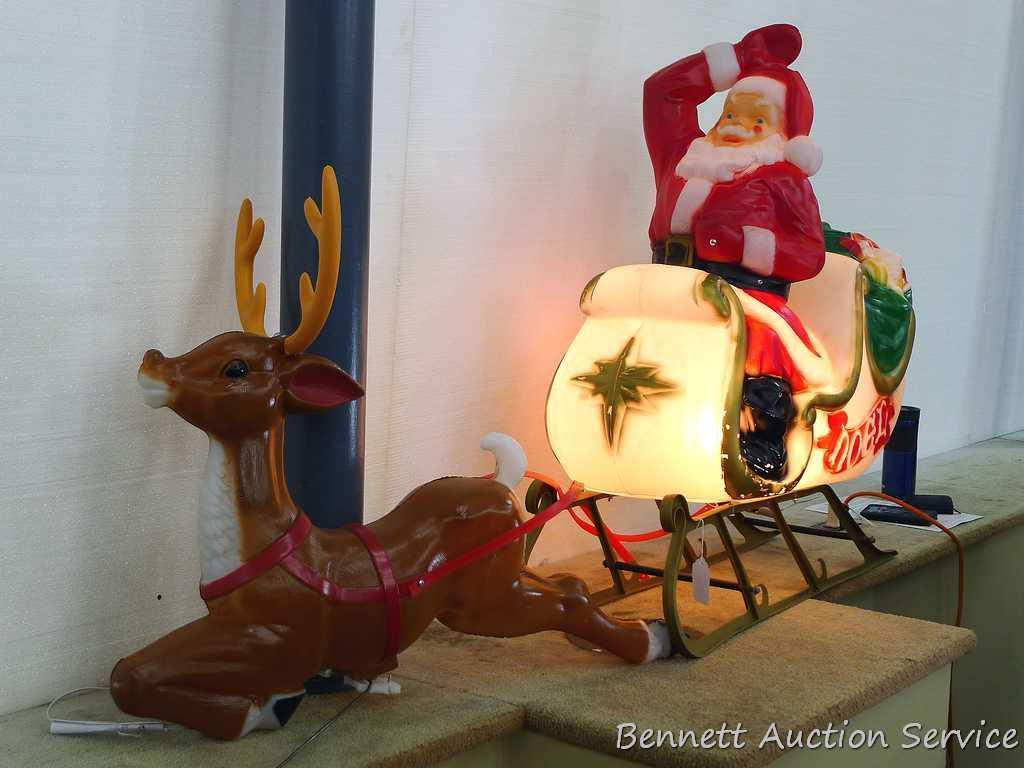 Santa in sleigh with reindeer yard decoration. Santa lights up, but reindeer might need a new bulb.