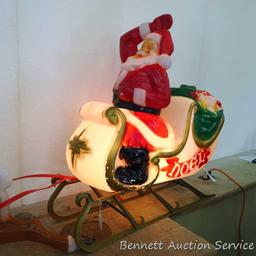 Santa in sleigh with reindeer yard decoration. Santa lights up, but reindeer might need a new bulb.