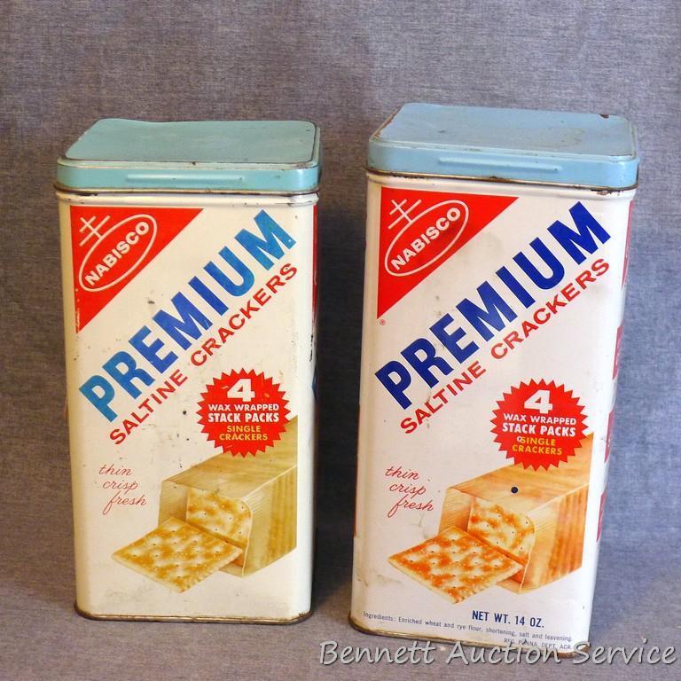 Two vintage Nabisco Premium saltine cracker tins are in overall good shape. Stand 9" tall.