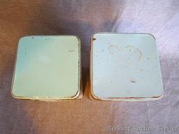 Two vintage Nabisco Premium saltine cracker tins are in overall good shape. Stand 9" tall.