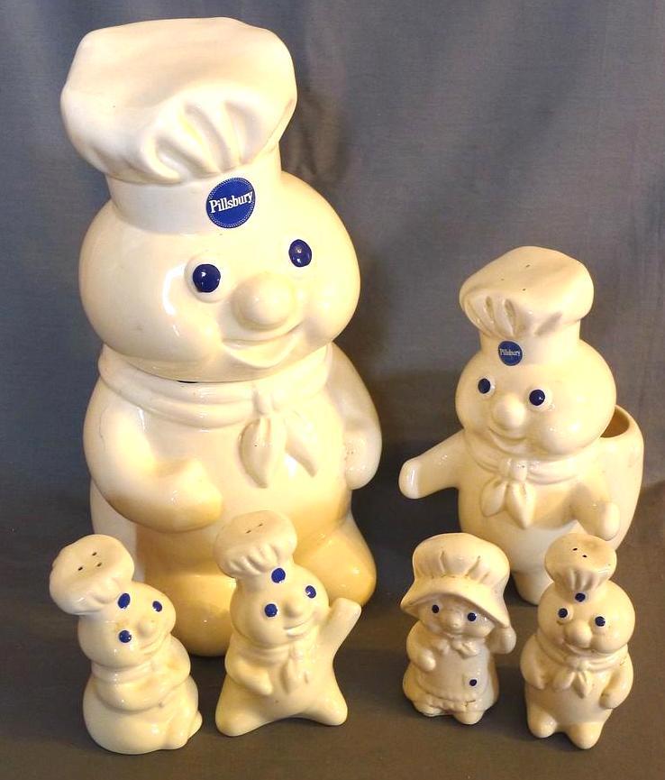 Pillsbury Dough Boy kitchen accessories including cookie jar, sink caddy, and two shaker sets.