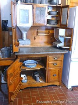 Beautiful antique Hoosier-style kitchen cabinet has flour sifter and metal lined drawer with vented