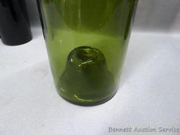 Tall green glass bottle with an interesting design stamped seal at base of bottle neck, measures 3"