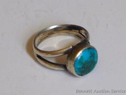 Ladies ring with turquoise accent is about a ladies size 8. No markings found.