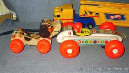 Vintage and newer toys including Fisher Price Bouncy Racer and Little Snoopy wooden pull toys. Also