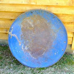 Well loved saucer style sled measures 27" and is old enough to have been stamped out of steel sheet.