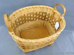 Nice woven basket with wooden bottom and legs. Measures approx. 12"x 14"x 16".