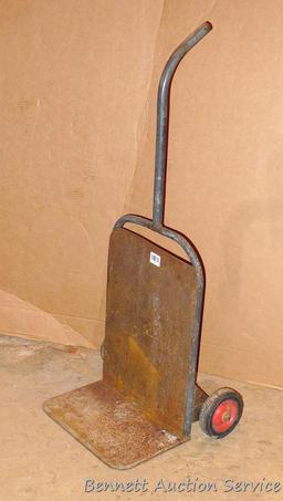 Metal hand cart measures 20.5" x 45" tall x 14". Feels very sturdy but needs one wheel replaced.