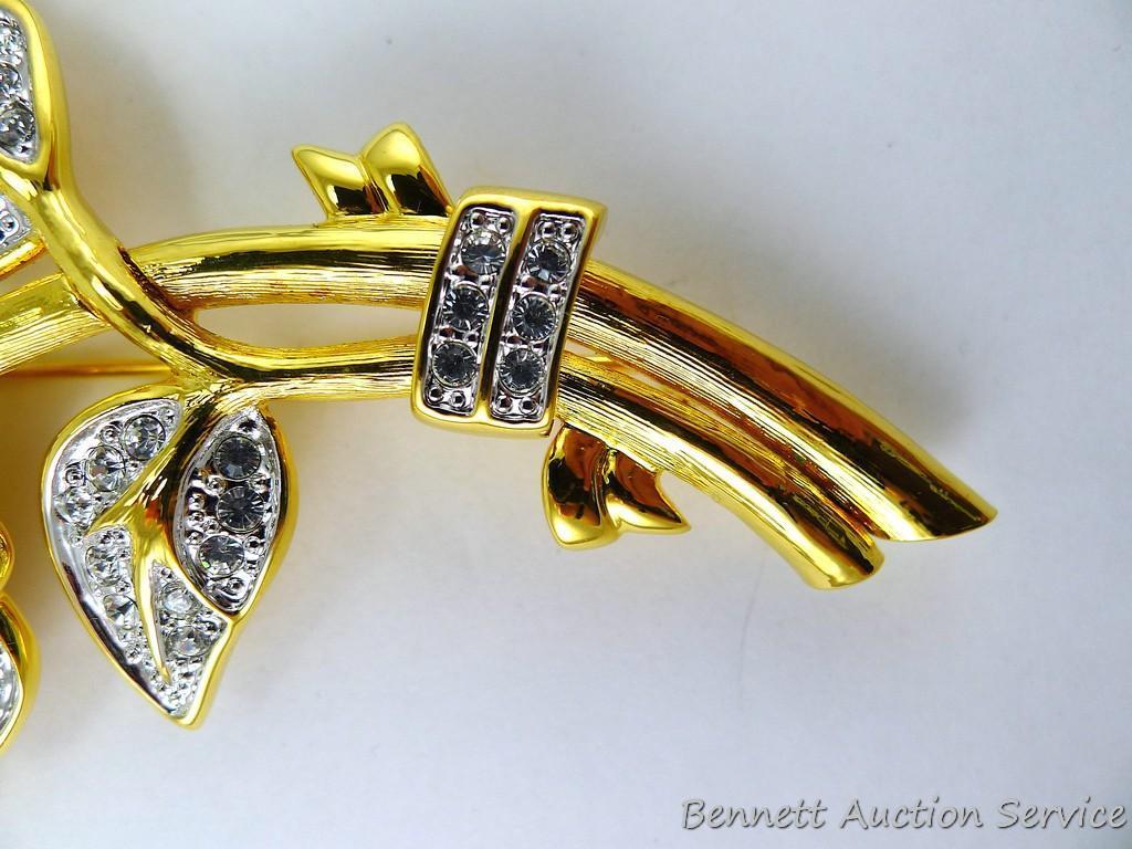 Gold toned and sparkly brooch measures 3-3/4" and if the box is any indication, it's part of the