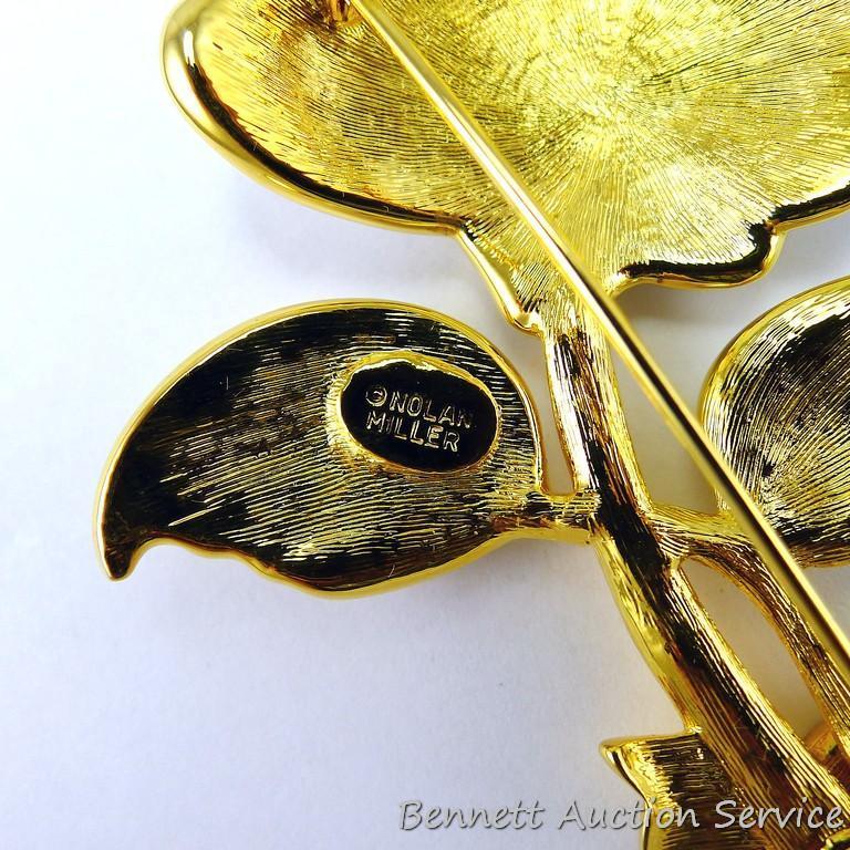Gold toned and sparkly brooch measures 3-3/4" and if the box is any indication, it's part of the