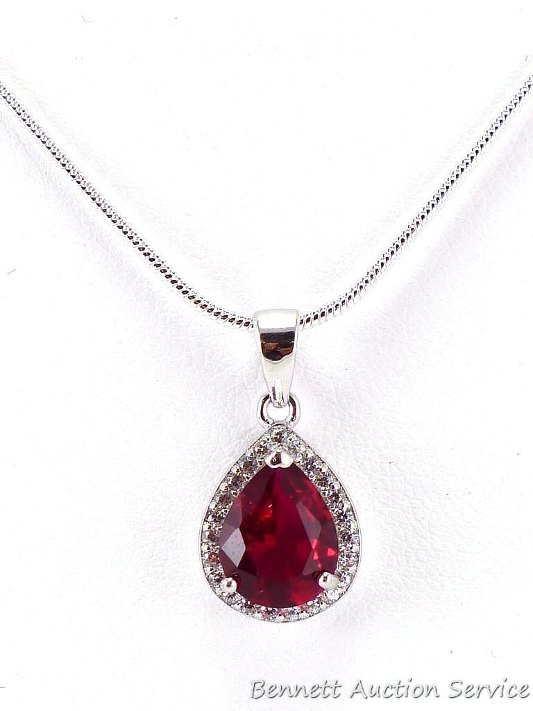 Seller's note states "2 CT Sterling silver ruby and white topaz pendant and chain". Measures overall