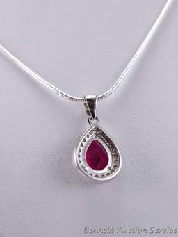 Seller's note states "2 CT Sterling silver ruby and white topaz pendant and chain". Measures overall