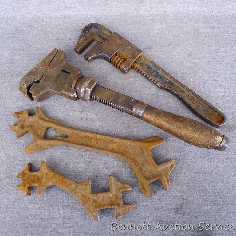 Antique wrenches includes 13" pipe wrench; 11" auto wrench; D239 specialty wrench and one other.