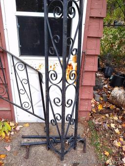 Wrought iron railing section is approx. 7' long; matching upright piece is approx. 8' tall.