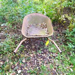 Antique wheel barrow will look great in your yard. Over 4' long.