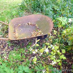 Antique wheel barrow will look great in your yard. Over 4' long.
