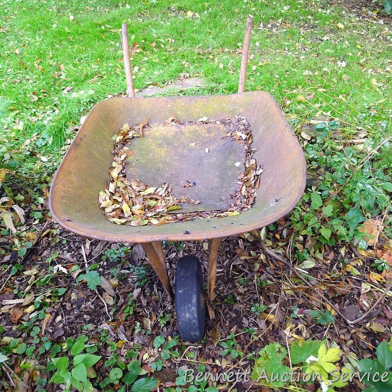 Antique wheel barrow will look great in your yard. Over 4' long.