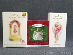 Three Hallmark Keepsake ornaments includes Barbie. Taller boxes are about 6". Come with packaging.