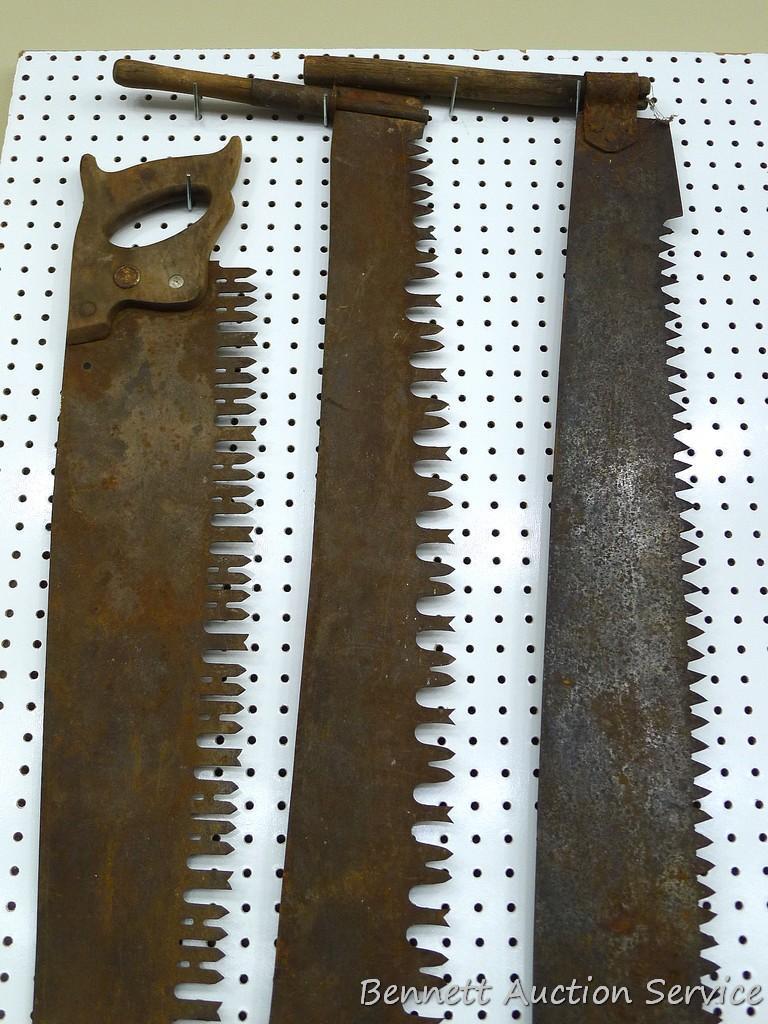 2 antique two man crosscut saws, longest is about 70" long and 5-1/2" wide; one man saw is 42" long.