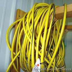 Heavy duty extension cord is approx. 100' long and has triple receptacle end. Looks like approx.