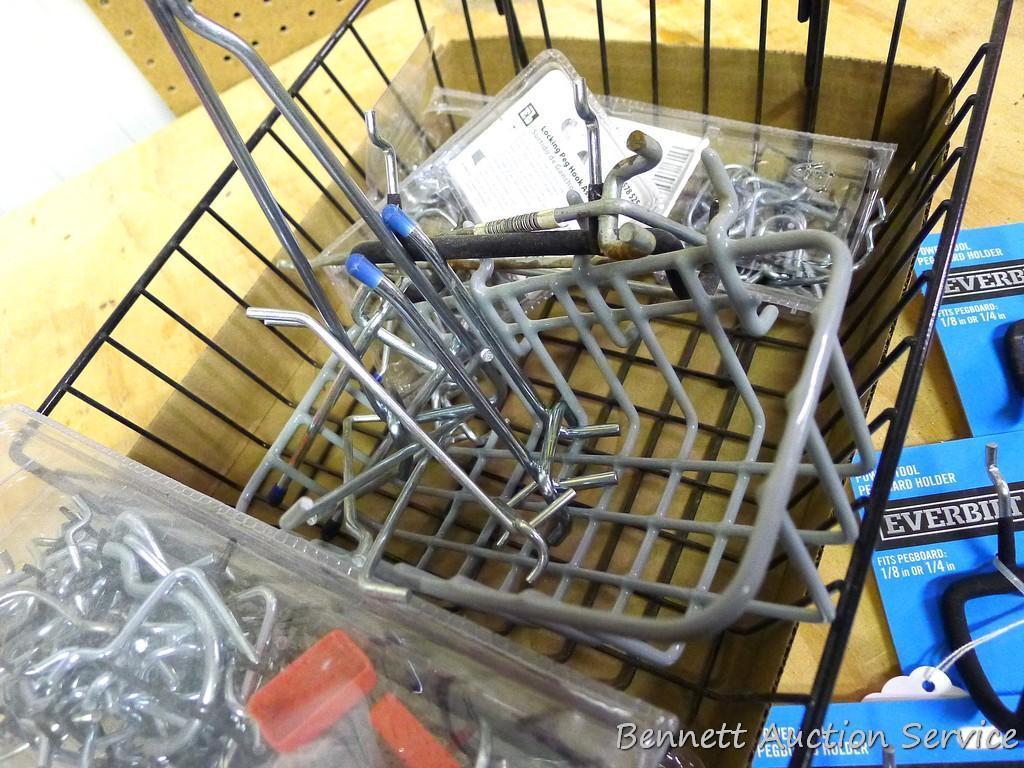 Quantity of peg board hooks and baskets of various sizes. Large basket is 13" x 12".