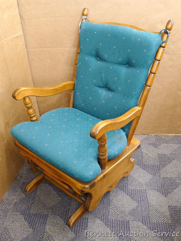 Wooden glider rocker moves smoothly and is about 23" x 23" x 38" tall. Some scuffs noted,
