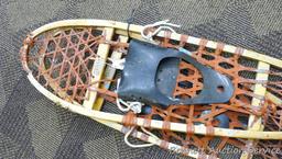 Pair of Iverson snowshoes 46-1/2" x 11" with rubber boot bindings. Shows a lot of use.