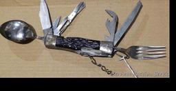 Really cool camp knife includes fork, spoon, corkscrew, knife, scissors, more. Roughly 4-3/4" x 2" x