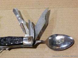 Really cool camp knife includes fork, spoon, corkscrew, knife, scissors, more. Roughly 4-3/4" x 2" x