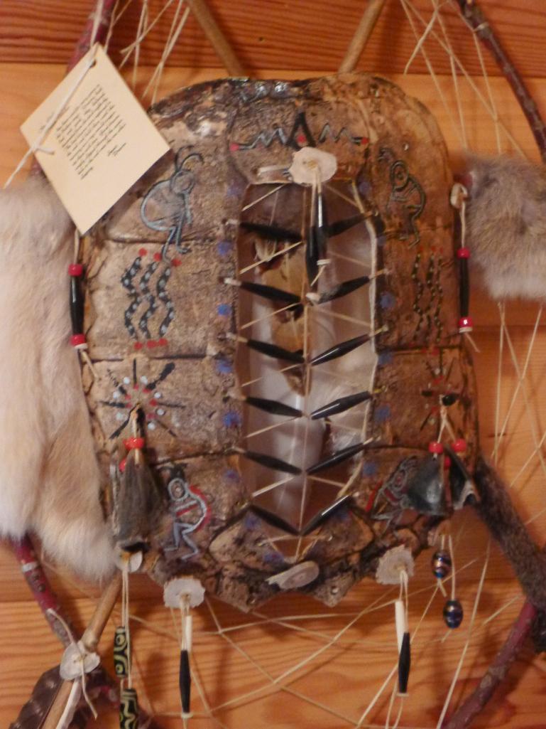Unique wall hanging with 2 wooden arrows, rabbit fur, turtle shell, antler slices and more. Measures