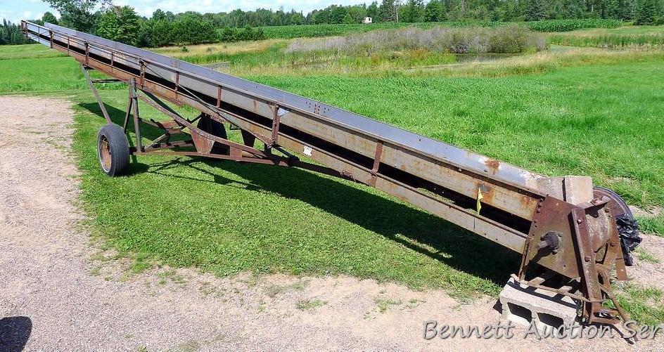 New Idea 45' grain elevator with 17-1/2" paddles. Has hand crank for adjusting height and 15" tires