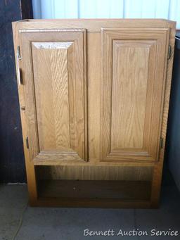 Wall mountable cabinet is about 24" x 9" x 33" high. Great for the craft room.