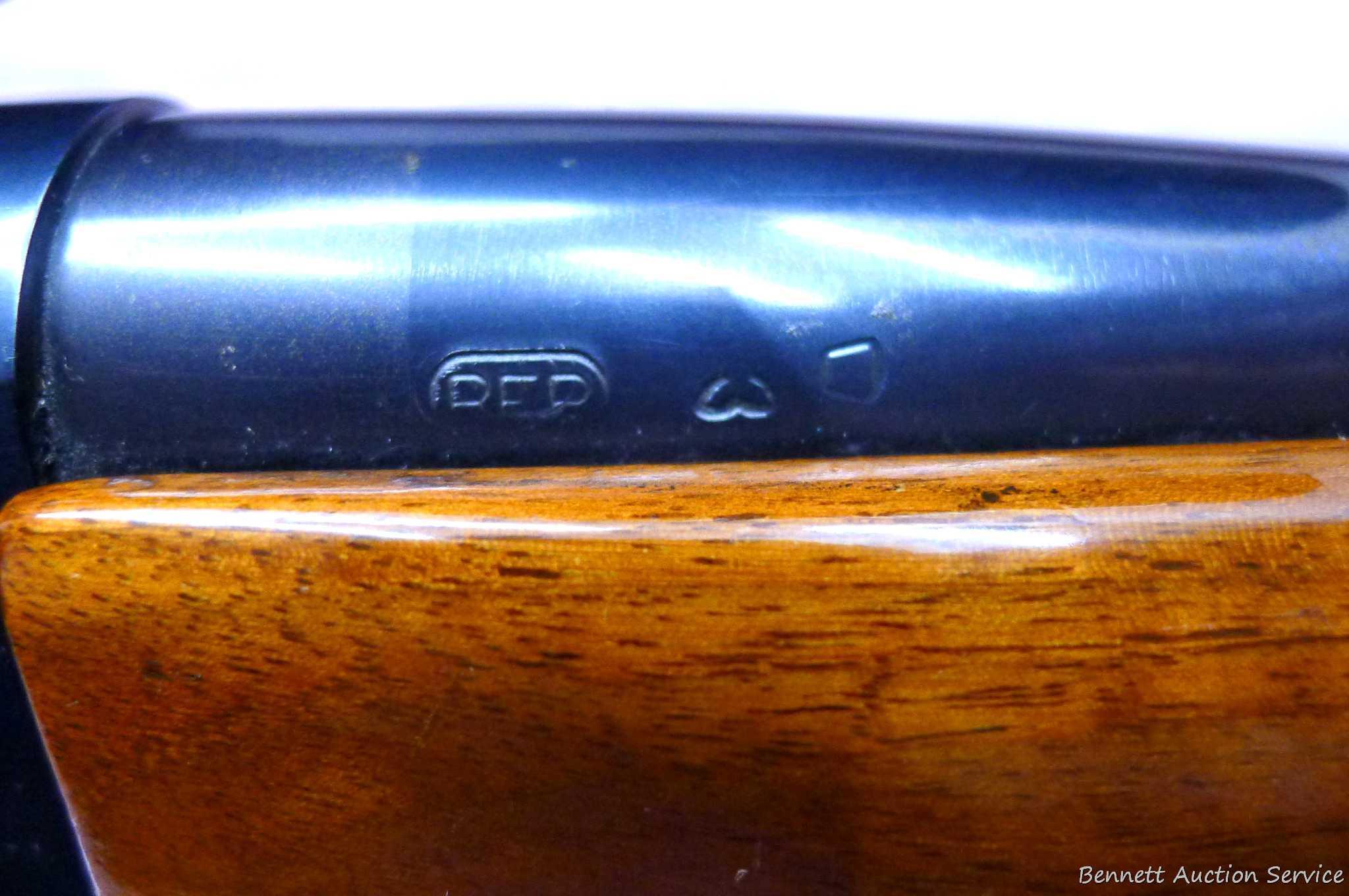 Remington Model 742 Woodsmaster semi-automatic rifle in .30-06 is topped with a 3-9 scope. Barrel is