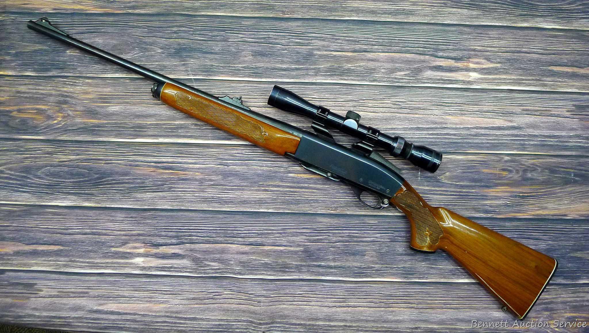 Remington Model 742 Woodsmaster semi-automatic rifle in .30-06 is topped with a 3-9 scope. Barrel is