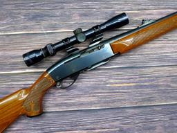 Remington Model 742 Woodsmaster semi-automatic rifle in .30-06 is topped with a 3-9 scope. Barrel is