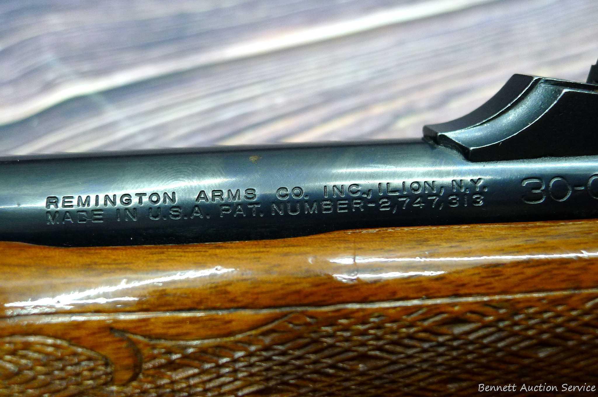 Remington Model 742 Woodsmaster semi-automatic rifle in .30-06 is topped with a 3-9 scope. Barrel is
