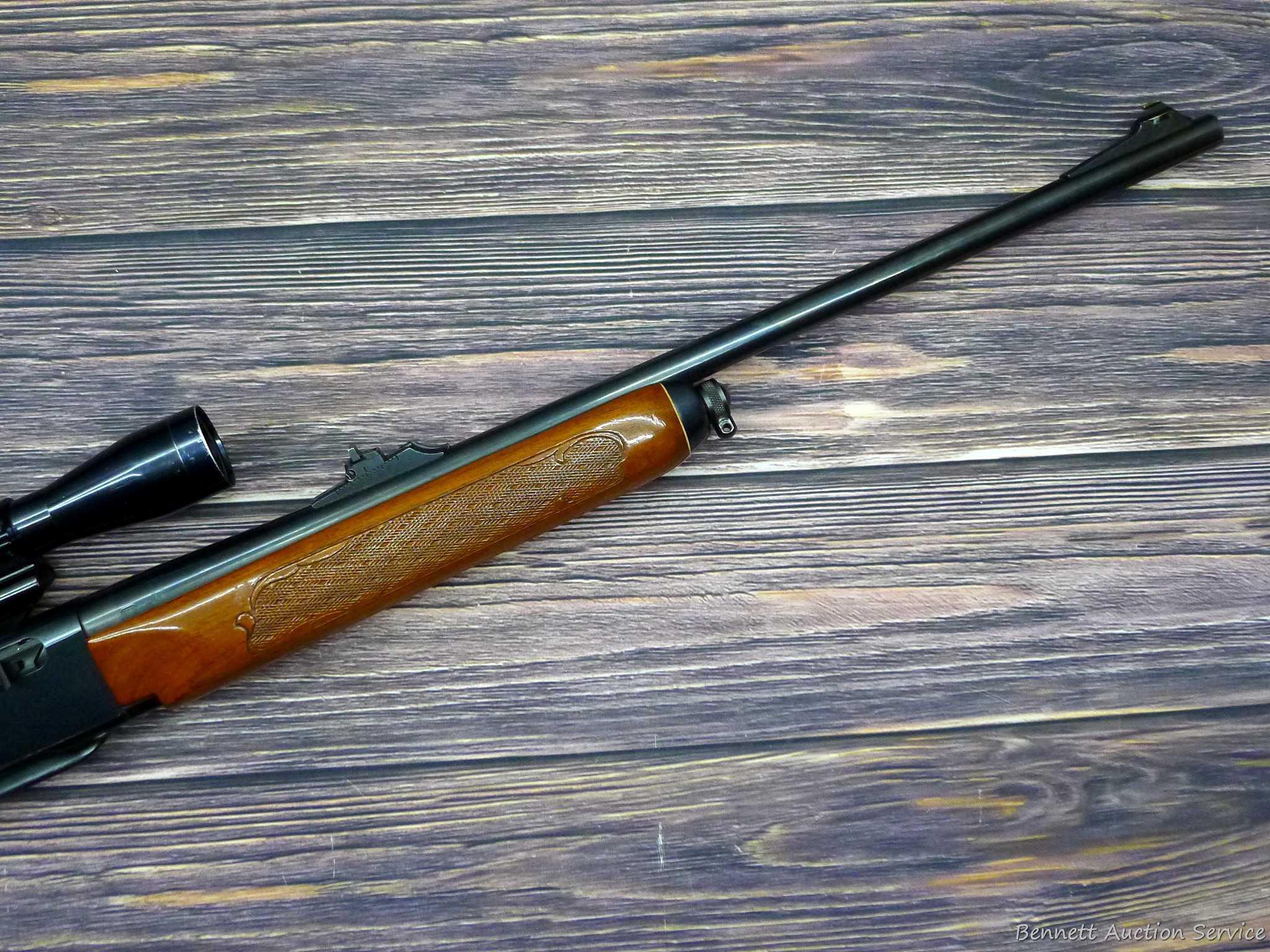 Remington Model 742 Woodsmaster semi-automatic rifle in .30-06 is topped with a 3-9 scope. Barrel is