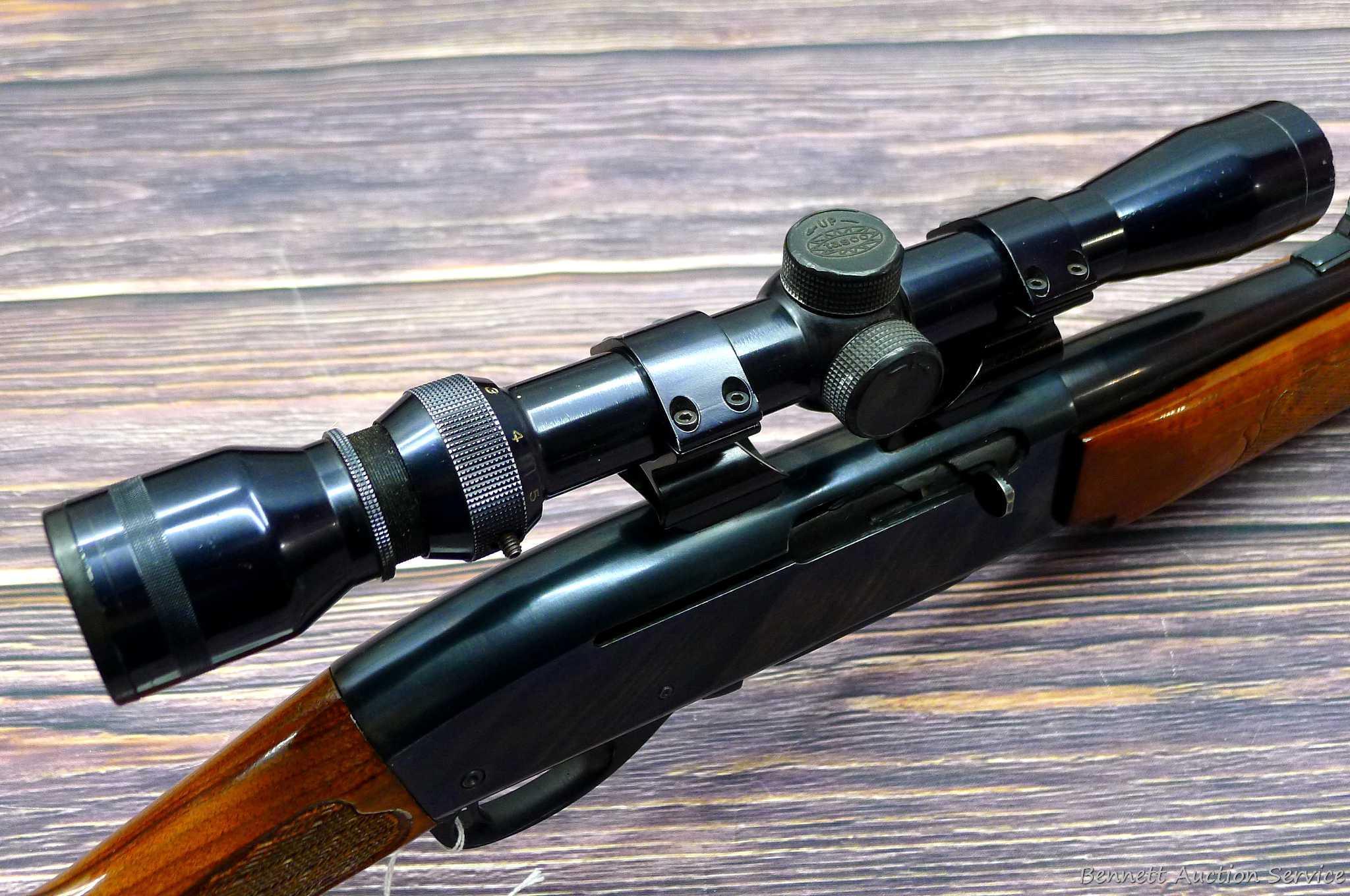 Remington Model 742 Woodsmaster semi-automatic rifle in .30-06 is topped with a 3-9 scope. Barrel is