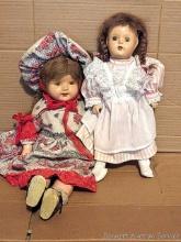 22" tall composite doll with a soft body and smaller plastic or composite doll with braids.