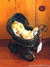 Wicker baby doll buggy is currently holding a 5" doll. Buggy measures approx. 12" x 9".