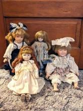 Three decorative porcelain dolls with stands, tallest is approx. 17".