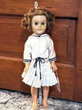 20" tall doll is reminiscent of Shirley Temple. Plastic parts feels a bit sticky, dress is in good
