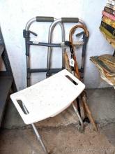 Located in basement, bring help to remove. Adjustable height shower seat; three canes and an