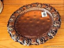 Solid copper Gregorian hanging plate or charger plate with ornate floral design on rim. Measures
