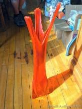 Large art glass vase is a reddish orange color and stands 2' tall, in good condition.